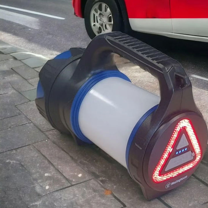 a blue and white light sitting on the side of a road