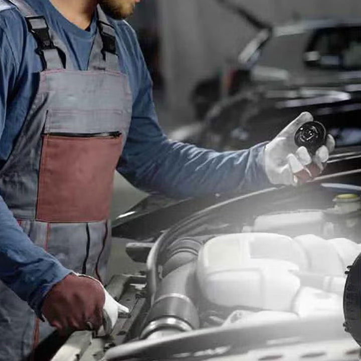 a man working on a car engine in a garage